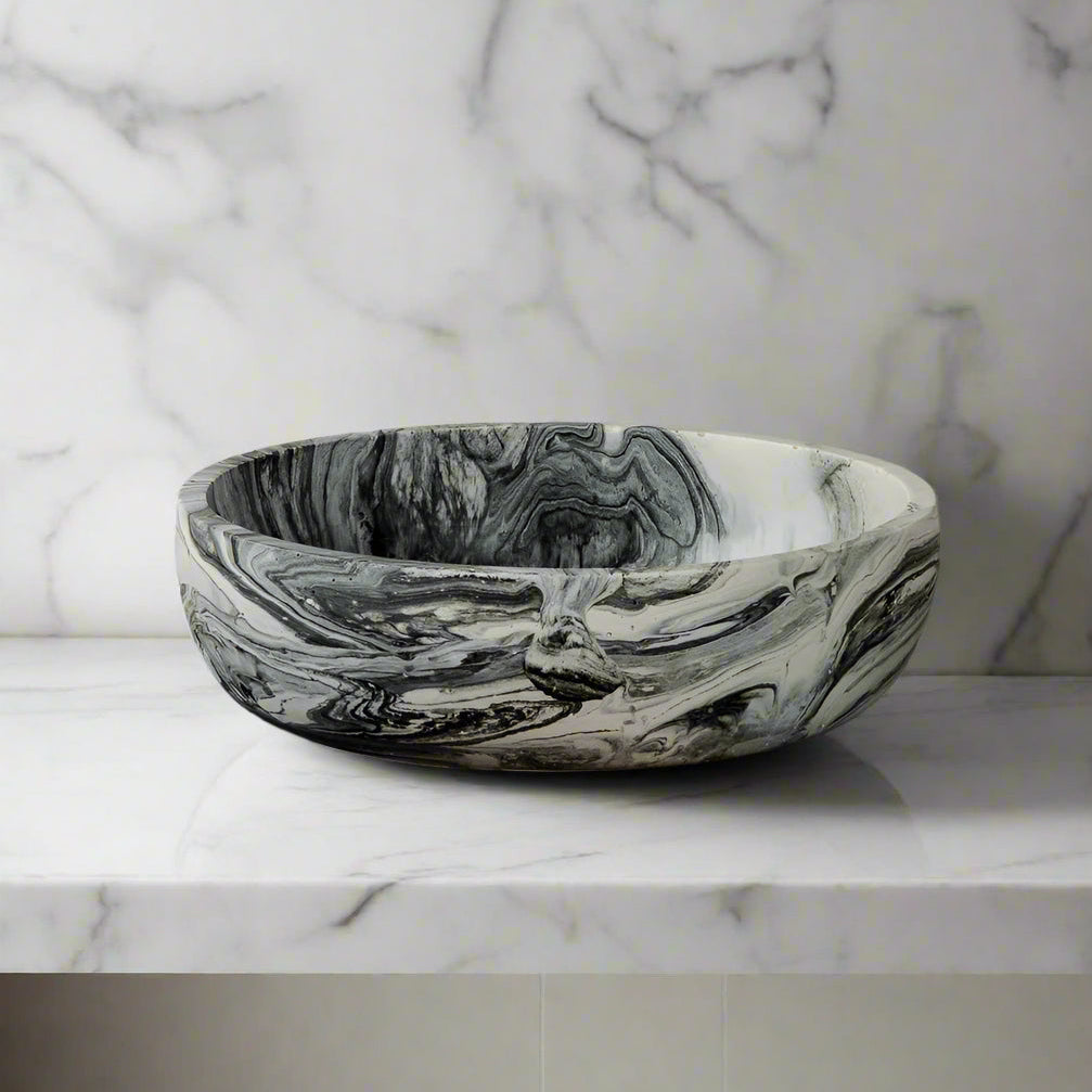 Marble-patterned bowl on a wooden surface with a gray background